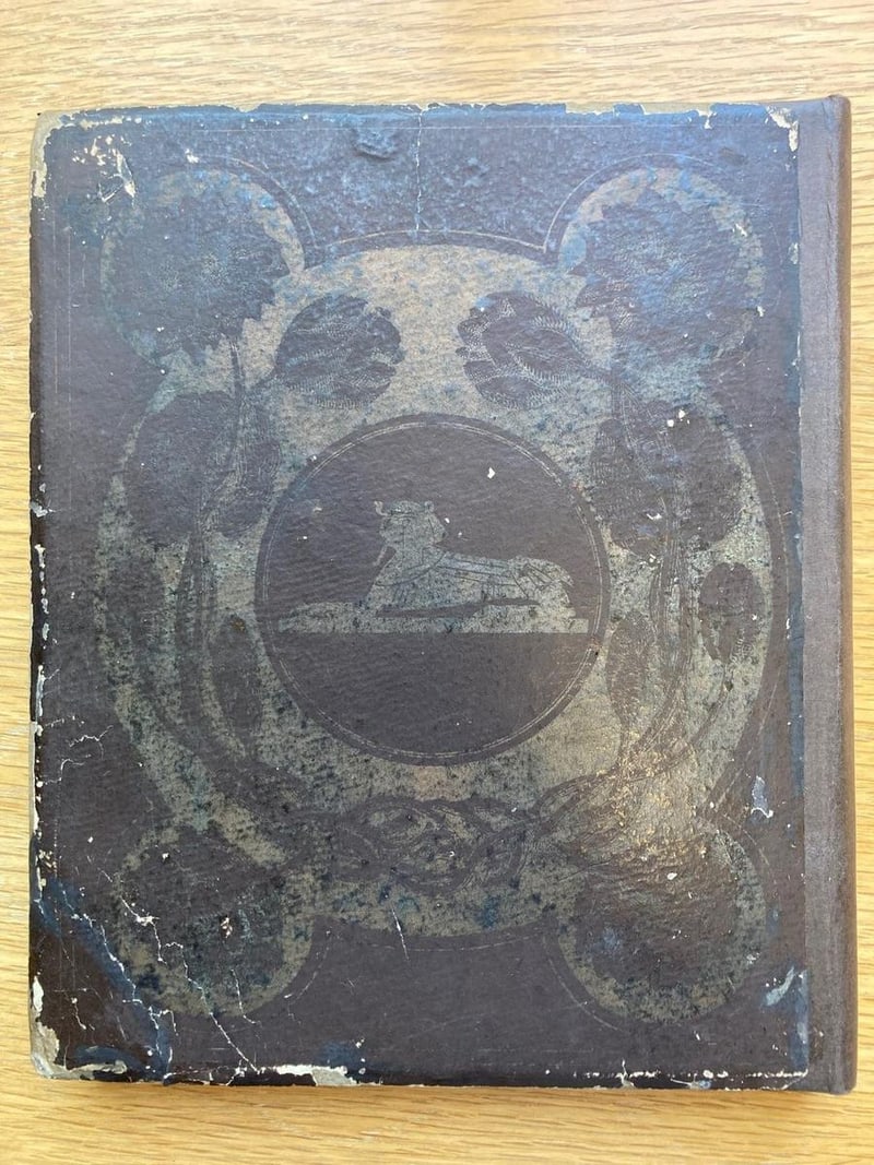 C041 heavily rubbed original rear board, dark puce, with sphinx medallion
