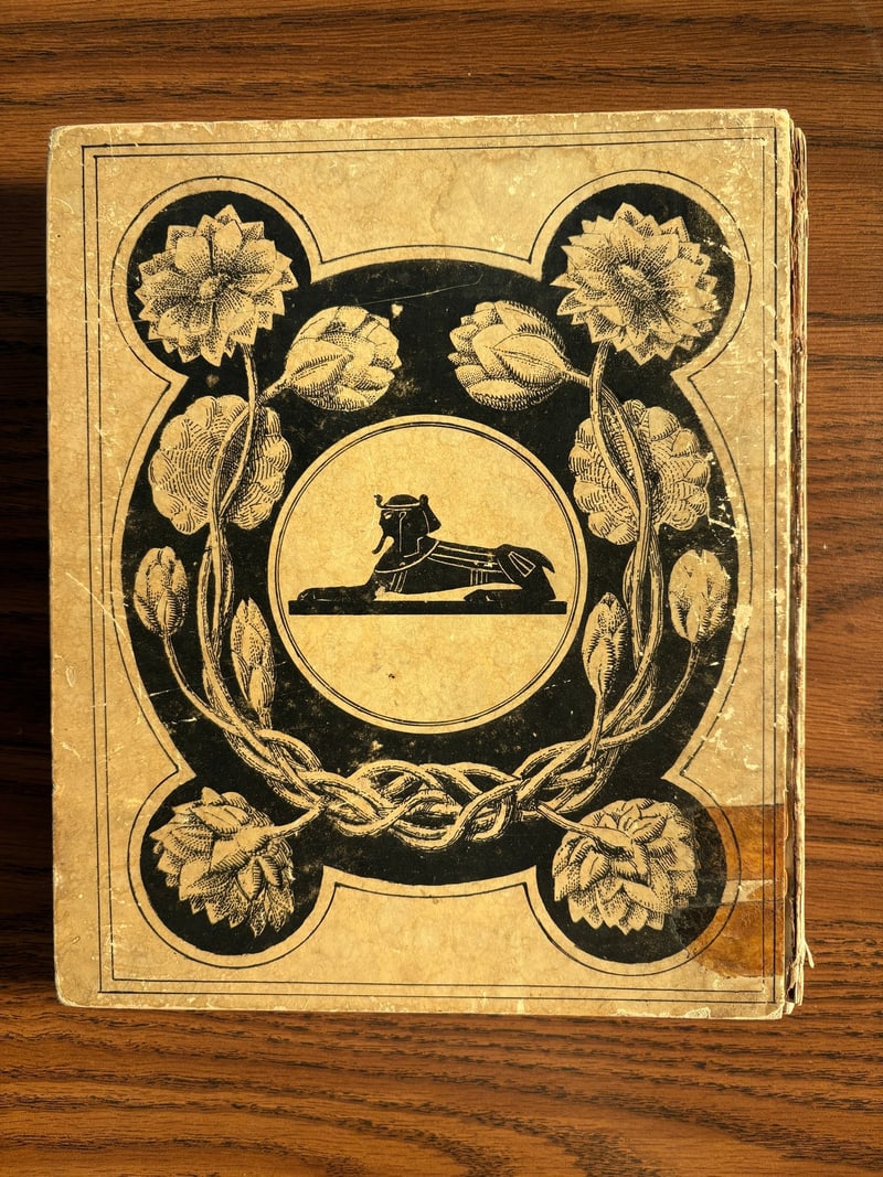 C093: Sphinx medallion within a floral wreath